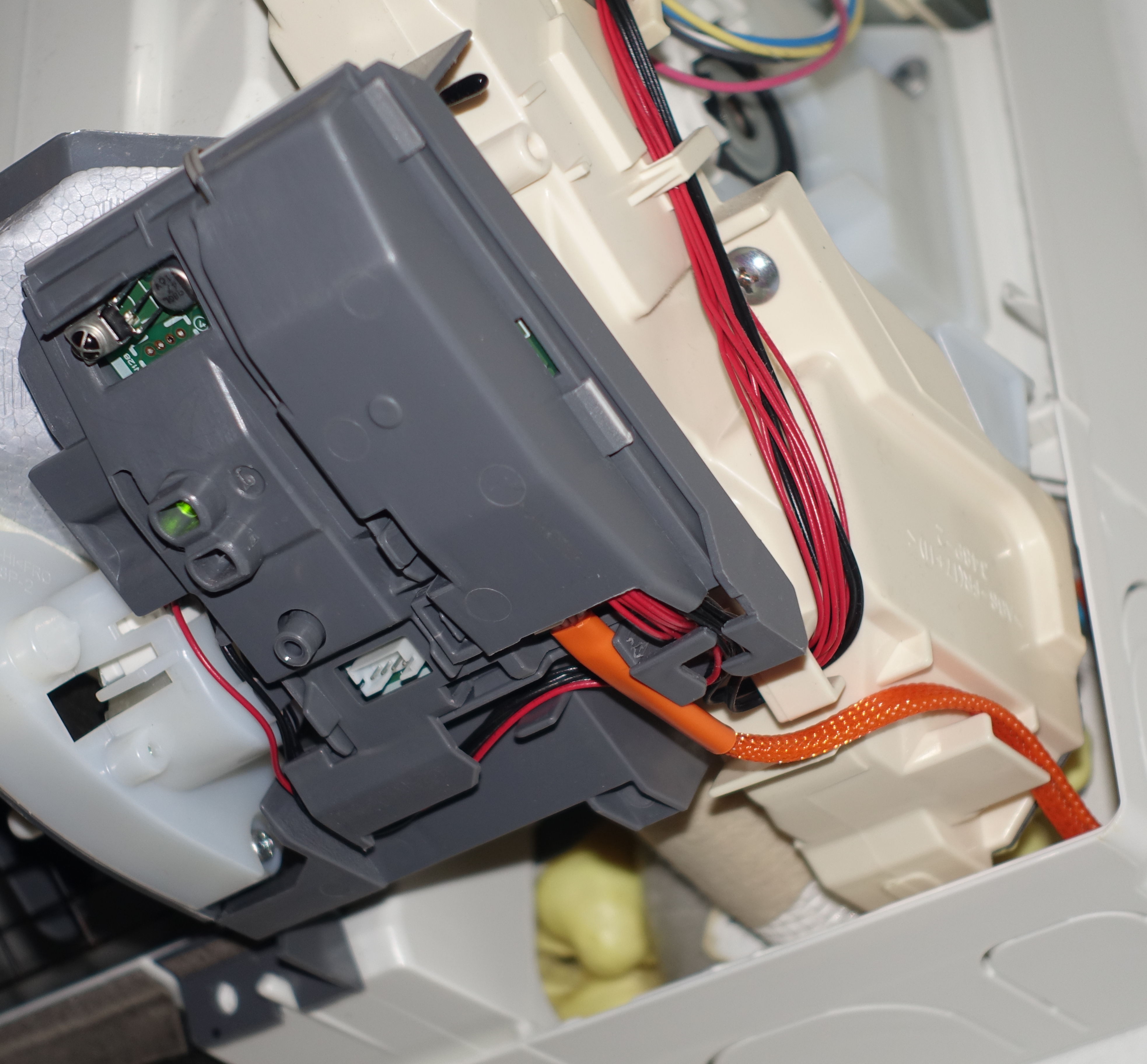 The controller mounted inside a ductless mini-split indoor unit with the CN105-to-Grove cable connected